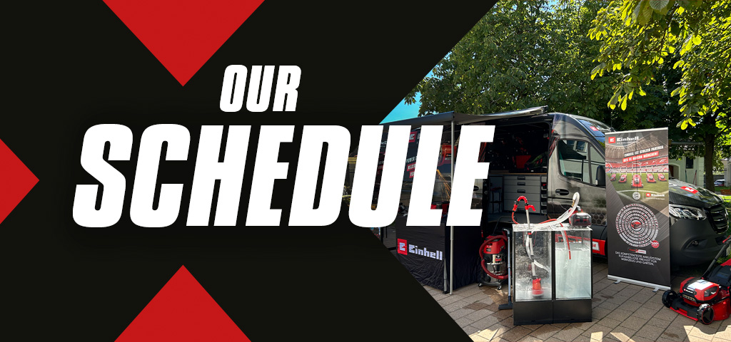 Billboard with the text "Our Schedule," next to a displayed Einhell van featuring products and promotional materials.